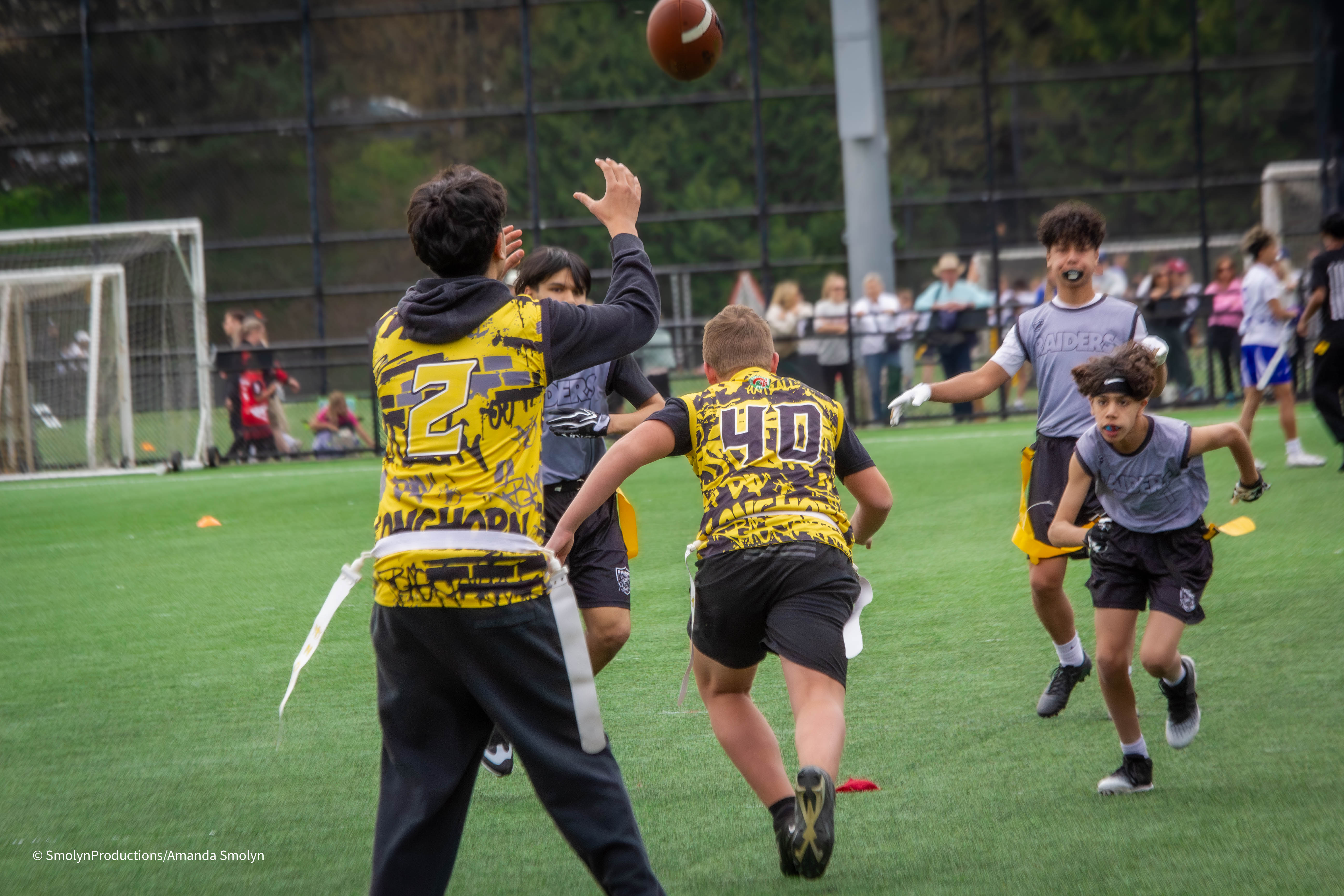Longhorns kids throwing a pass in a flag football game